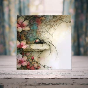 May include: A square decorative tile featuring a black spider with a red marking resting on a stone ledge. The scene is surrounded by delicate spiderwebs and soft pink cherry blossom flowers with green stems against a light background.