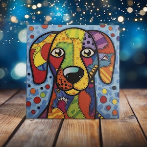 May include: A colorful, abstract painting of a dog's face. The dog has a yellow, orange, red, blue, green, and purple patterned face with a black nose and white spots. The background is a light blue with white dots.