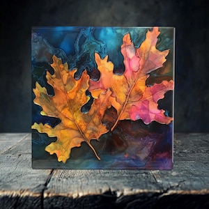 May include: Three autumn leaves in shades of orange, yellow, and red are painted on a dark blue background with swirling patterns. The leaves are detailed with veins and edges.