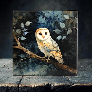 May include: A white and brown barn owl with yellow eyes perched on a branch against a dark blue and black watercolor background.