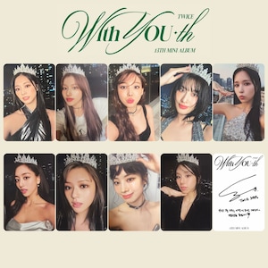 May include: A collage of nine photographs featuring a K-pop girl group. The photos show the members of the group wearing crowns and posing in front of a city skyline at night. The title of the album is "TWICE With You*th 13TH MINI ALBUM".