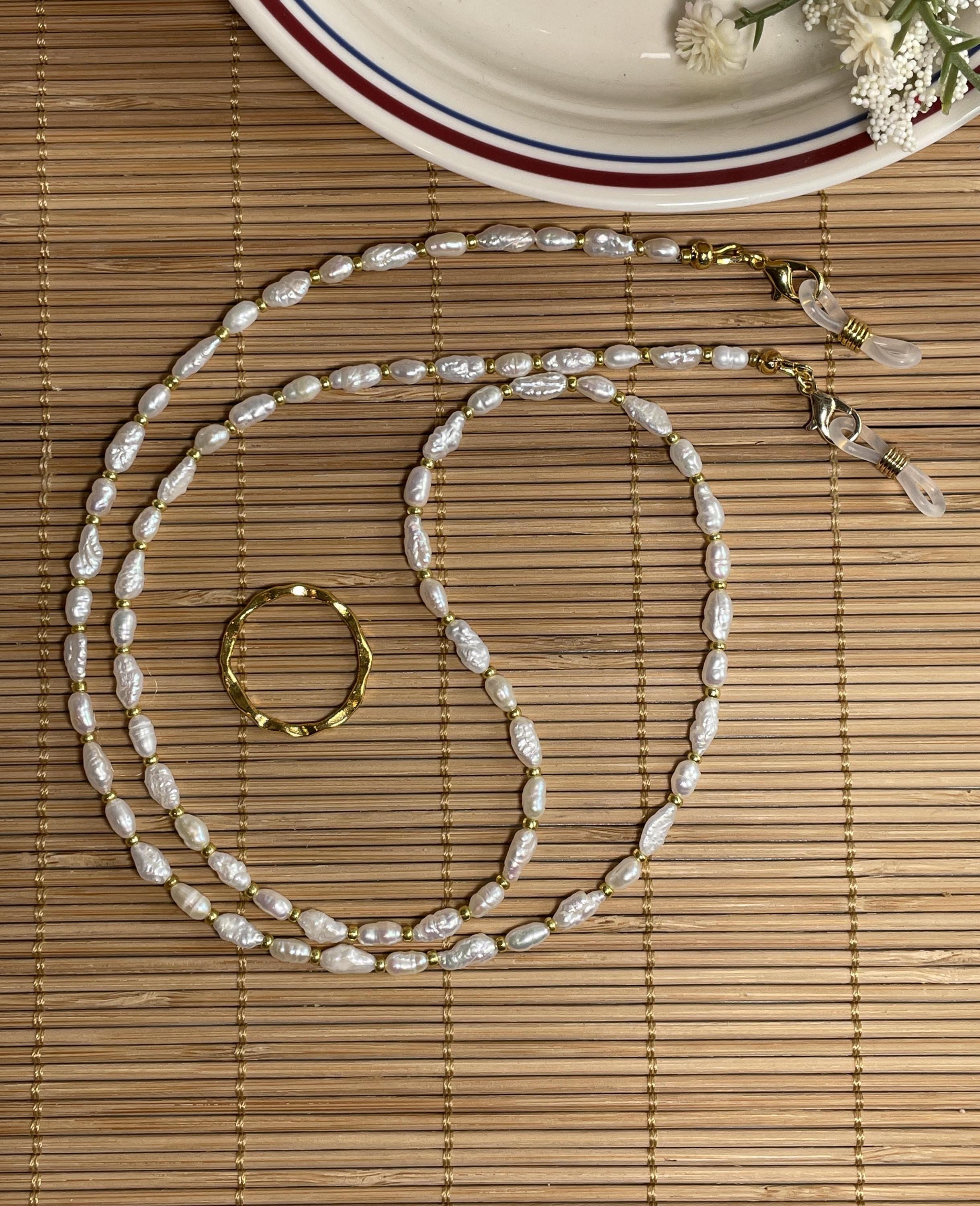 Eyeglass chain; Japanese rice pearls and gold glass beads. Lobster clasp. 25" long.