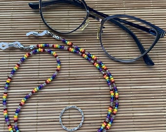 Bead chain to hold eyeglasses and masks.  Small rainbow colored and clear glass beads. Silicone grips, lobster clasps, round dangle.
