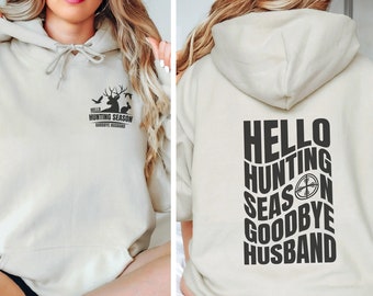 May include: A beige hoodie with a black graphic on the front that says "Hello Hunting Season Goodbye Husband" and a black graphic on the back that says "Hello Hunting Season Goodbye Husband" with a target symbol.