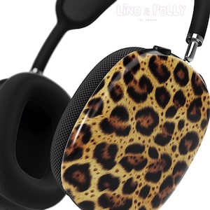 Könnte beinhalten: Schwarze Kopfhörer mit Leopardenmuster. Die Kopfhörer haben einen schwarzen Kopfbügel und Ohrmuscheln mit einem Leopardenmuster auf der Außenseite.