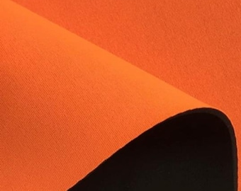 May include: A close-up of orange neoprene fabric with a black edge. The fabric has a textured surface.