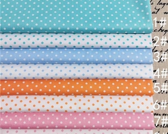 May include: Eight fabric swatches with white polka dots on different colored backgrounds. The colors are turquoise, light blue, white, orange, pink, and white. The swatches are stacked on top of each other.