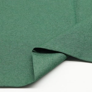 May include: A close-up of a dark green fabric with a textured surface. The fabric is folded in half, showing the inside of the fabric. The text "2#" is visible in the top right corner of the image.