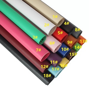 May include: Eighteen rolls of faux leather in various colours, including black, white, red, green, brown, and blue. Each roll is labelled with a number from 1 to 18.
