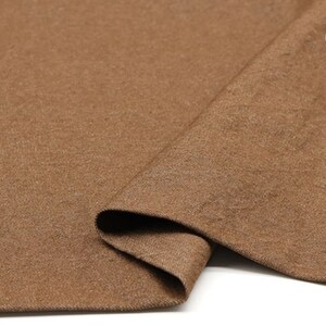 May include: Close-up of a brown fabric with a textured surface. The fabric is folded in half and the number "6#" is visible in the top right corner.