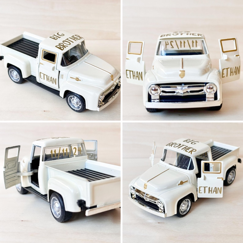 May include: White toy pickup truck with gold lettering that says "Big Brother" and "Ethan". The truck has an open door and bed.