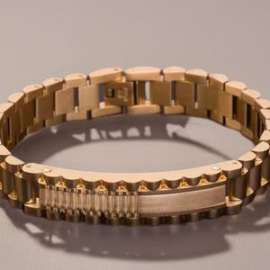 May include: A gold-toned metal bracelet with a textured, interlocking design. The bracelet has a clasp closure.