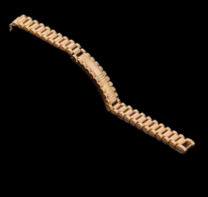 May include: A gold-toned metal watch band with a linked design.