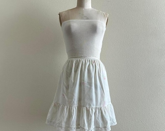 handmade white cotton mini skirt with pink floral embroidery and ruffle bottom