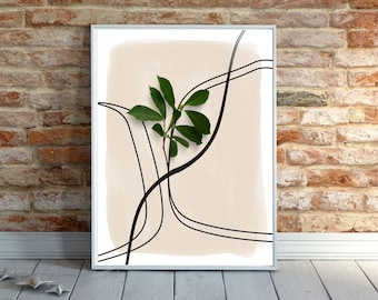 May include: A framed print with a beige background and black abstract lines. A green leaf branch is centered in the print.