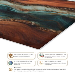 May include: A rectangular tempered glass board with a 0.24 inch thickness, featuring a printed abstract design of swirling brown wood grain patterns and flowing teal and blue liquid-like ribbons. The surface has a textured ribbed finish.