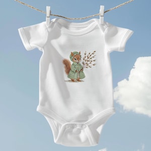May include: White baby onesie with a cute illustration of a squirrel wearing a green coat and holding a branch of willow.