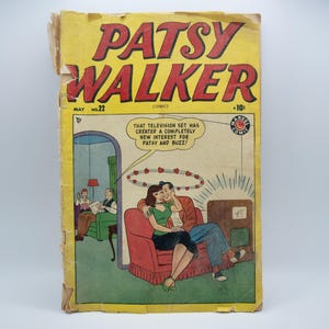May include: A vintage comic book cover featuring a couple sitting on a couch. The cover is yellow with red and black text that reads "Patsy Walker" and "May 22, Comics, 10 cents". The text "That television set has created a completely new interest for Patsy and Buzz!" is in a speech bubble above the couple.