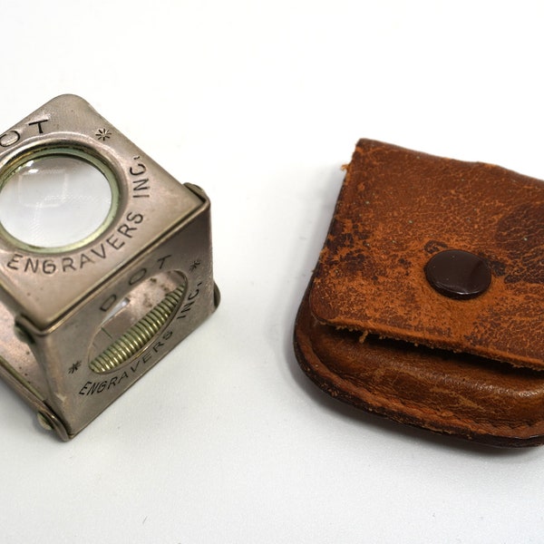 Folding vintage brass printers or jewelry loupe with a brown snap leather snap case