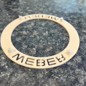 Backside with 4 Posts as shown in photo, aligns and  snaps onto wheel securely.