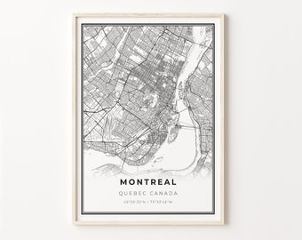 May include: A framed black and white map of Montreal, Quebec, Canada. The map details the city's streets, waterways, and infrastructure. The city name and coordinates are printed at the bottom of the map. The frame is a light wood color.