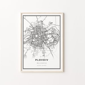 May include: Black and white line art map of Plovdiv, Bulgaria. The map shows the city streets and landmarks. The text "Plovdiv, Bulgaria, 42°9'N | 24°45'E" is printed below the map.