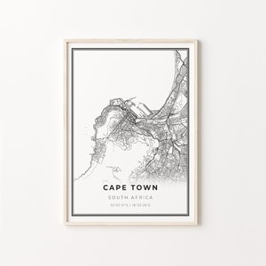 May include: Black and white map print of Cape Town, South Africa. The map shows the city's streets and coastline. The text "Cape Town, South Africa" and the coordinates "33°55'31"S | 18°25'26"E" are printed below the map.