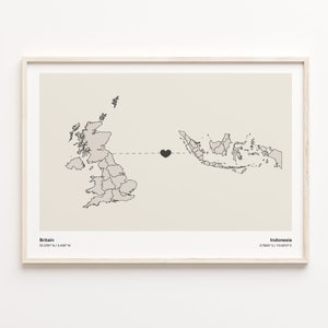 May include: A minimalist print featuring a map of Great Britain and Indonesia connected by a dotted line with a black heart in the middle. The text "Britain 56.3789° N / 3.4360° W" is at the bottom left and "Indonesia 0.7887° S / 113.8219° E" is at the bottom right.