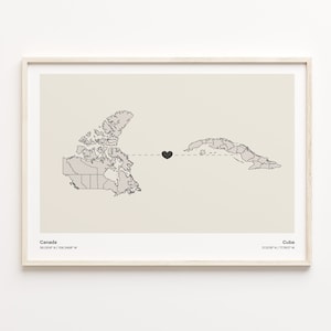 Könnte beinhalten: Gerahmter Druck mit minimalistischem Kartendesign. Er zeigt Umrisse von Kanada und Kuba, verbunden durch eine gestrichelte Linie und ein schwarzes Herz. Der Druck enthält die Namen und Koordinaten jedes Landes.