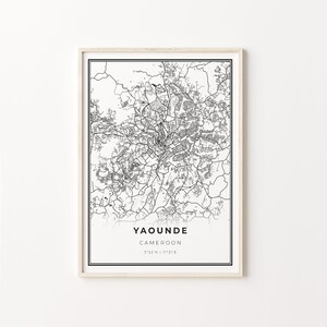 May include: A black and white map print of Yaounde, Cameroon, with the city's name, country, and coordinates printed below the map.