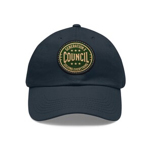 Puede incluir: Una gorra de béisbol azul marino con un parche bordado en verde y dorado que dice "Generation X Council Solving Everything".