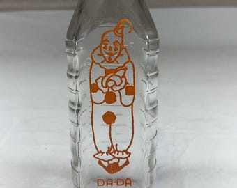 Biberón de cristal vintage Samuel Callet Co. DA-DA con diseño de payaso, años 50-1970, color naranja pirograbado.