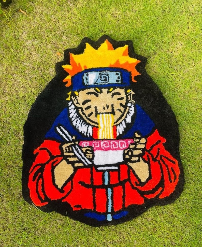 May include: A colourful rug featuring an anime character with orange hair, a red jacket, and blue trousers, eating ramen noodles from a bowl.