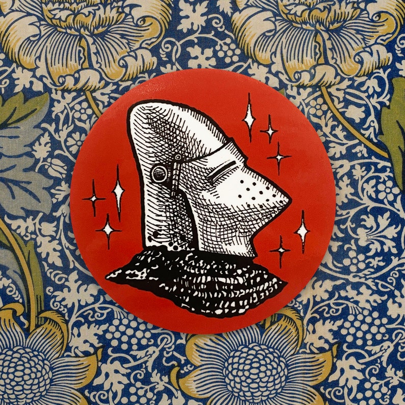 May include: A red circle with a black and white illustration of a knight's helmet with a visor. The helmet is surrounded by white stars.