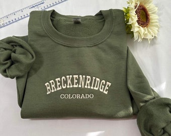 May include: A green sweatshirt with the text "Breckenridge Colorado" embroidered in white.