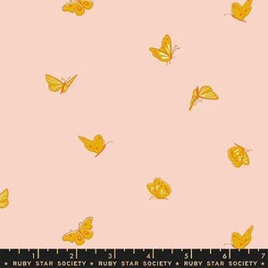 May include: A light pink fabric featuring a repeating pattern of yellow and orange butterflies in various flight positions. A black ruler at the bottom edge shows measurements in inches, with the text RUBY STAR SOCIETY printed repeatedly.