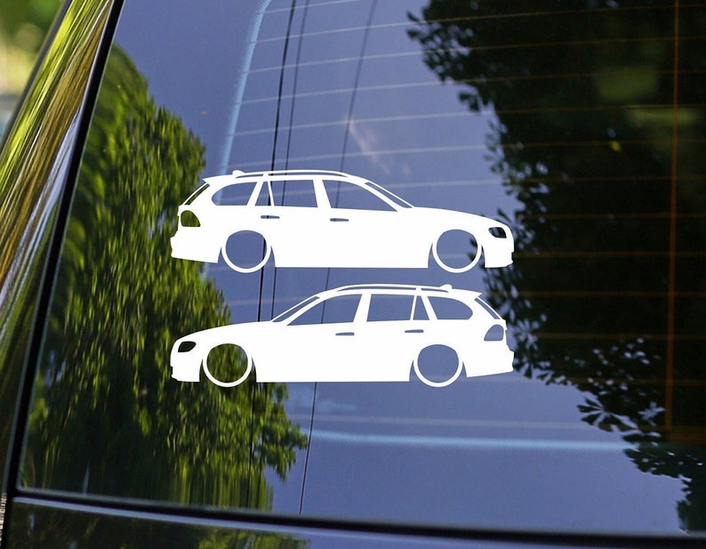 May include: Two white silhouette decals of a station wagon car on a blue background. The decals are layered on top of each other.