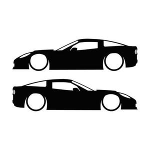 May include: A black silhouette graphic featuring two sports cars in profile view. The top car faces left, while the bottom car faces right. Both vehicles are depicted with clean, solid black lines, showcasing the aerodynamic body shape.