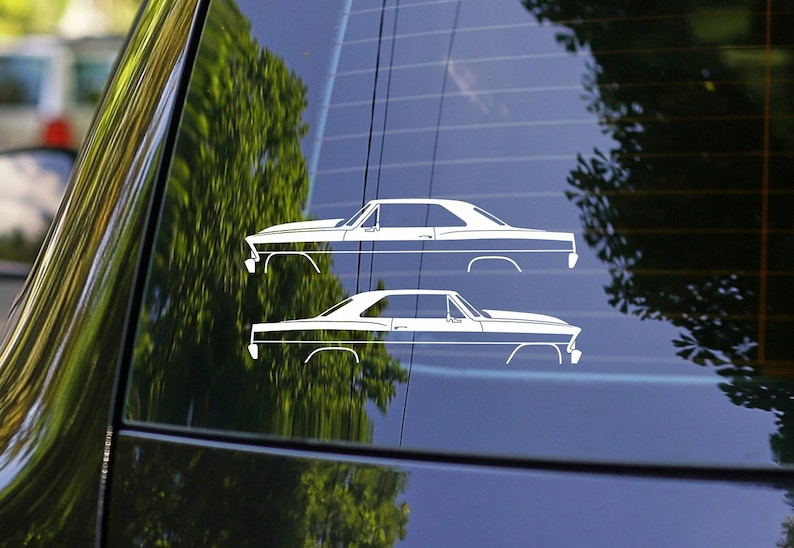 May include: Two white silhouette decals of a 1967 Chevrolet Camaro on a black car window.