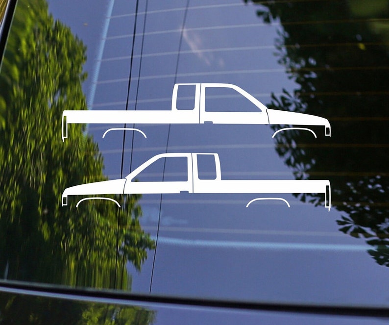 May include: Two white silhouette decals of a pickup truck. The decals are on a blue background.