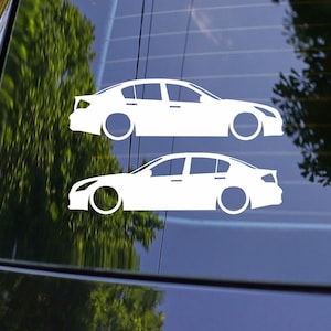 May include: Two white vinyl car silhouette decals of a sedan. The decals are on a blue car window.