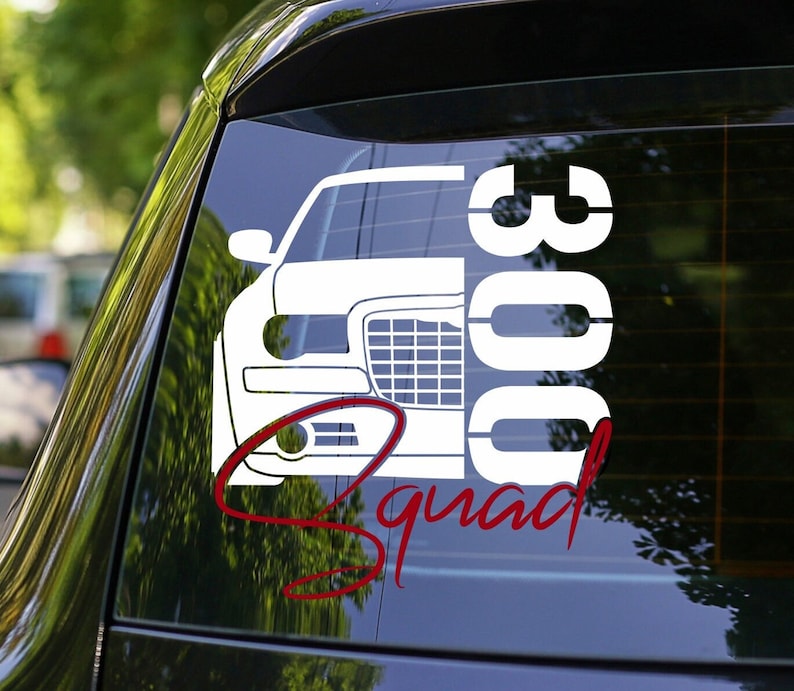 May include: White vinyl decal of a car with the text "300 Squad" in red cursive. The car is a Chrysler 300.