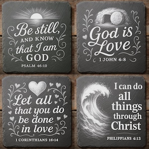 May include: Four square slate coasters with white script and illustrations. Each coaster features a different inspirational quote from the Bible. The quotes include "Be still, and know that I am God," and "God is Love."