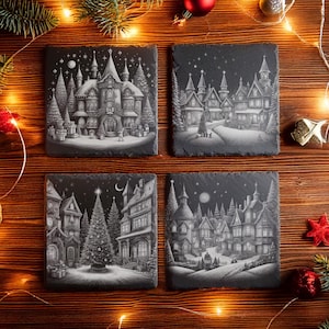 May include: Four square slate coasters with detailed black and white illustrations of a Christmas village scene. Each coaster features buildings, trees, and a starry night sky. The coasters are arranged on a wooden surface with festive decorations.