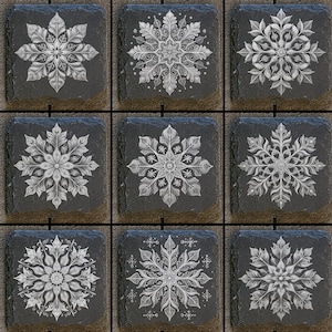 May include: Set of nine black slate coasters with white snowflake designs. Each coaster features a different intricate snowflake pattern.