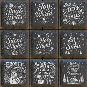 May include: Nine square slate coasters with white lettering and festive holiday designs. Each coaster features a different Christmas-themed phrase, including "Jingle Bells," "Joy to the World," and "Deck the Halls."