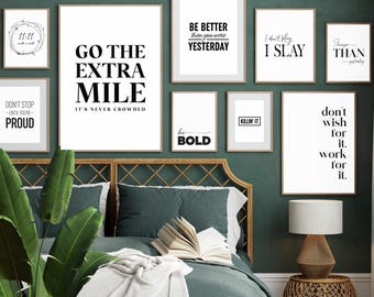 May include: A bedroom interior with a green headboard and a white blanket on the bed. There are several framed prints on the wall with motivational quotes, including "Go the Extra Mile", "Be Better Than You Were Yesterday", "I Don't Play I Slay", and "Don't Wish For It Work For It".