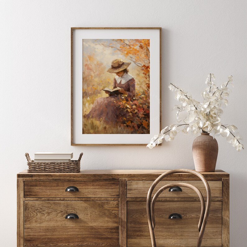 Vintage fall woman reading book fall painting oil painting art print displayed in an antique frame against a white background. The painting features intricate brushwork and colors. The shop name Lexington Prints is written out beneath the wall art.