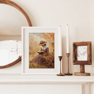 Vintage fall woman reading book fall painting oil painting art print displayed in an antique frame against a white background. The painting features intricate brushwork and colors. The shop name Lexington Prints is written out beneath the wall art.