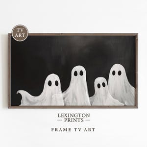 May include: A black and white framed print of five ghosts on a black background. The print has the text "LEXINGTON PRINTS" and "FRAME TV ART" below the image.